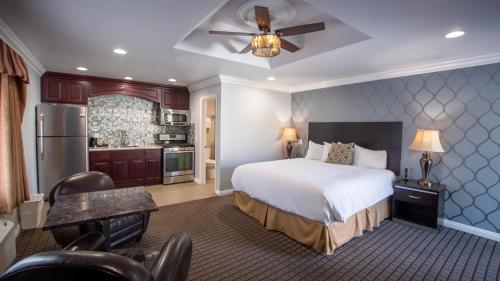 a hotel room with a bed and a kitchen at Crystal Lodge Motel in Ventura