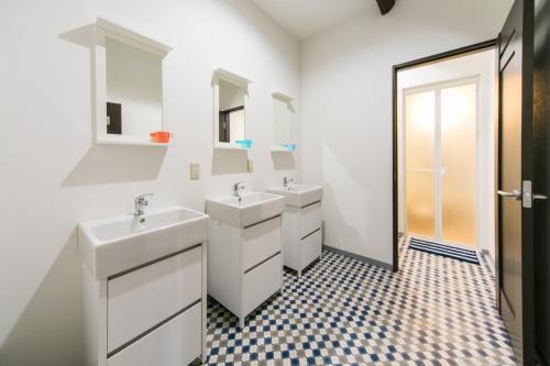 a white bathroom with two sinks and a mirror at Osaka - House / Vacation STAY 6221 in Osaka