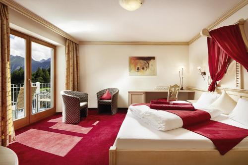 a hotel room with two beds and a large window at Alpine Resort Goies Superior in Ladis