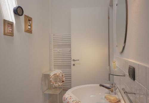 a white bathroom with a sink and a shower at Maestrale 2 in Marina di Pietrasanta
