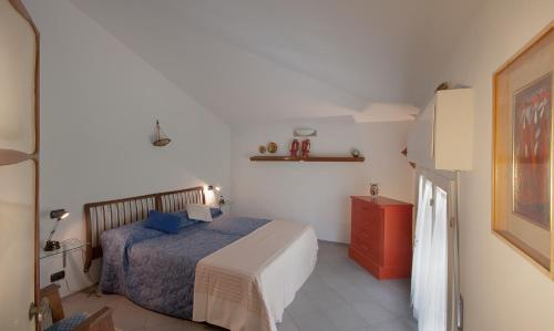 a bedroom with a bed and a red cabinet at Maestrale 2 in Marina di Pietrasanta