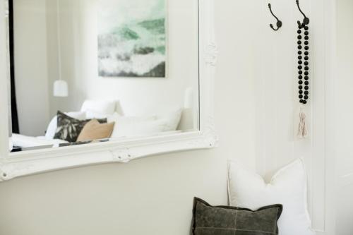 a mirror hanging on a wall next to a couch at Old Market Inn in Port Fairy