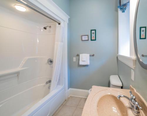 a bathroom with a tub and a sink at Chipman Hill Suites - Union Street in Saint John