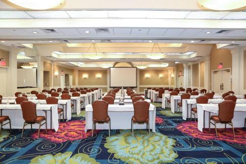 a conference room with tables and chairs and a whiteboard at Crowne Plaza Virginia Beach Town Center by IHG in Virginia Beach