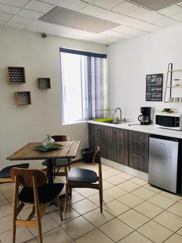 a kitchen with a table and chairs and a kitchen with a sink at Gdl Collection for families in Guadalajara