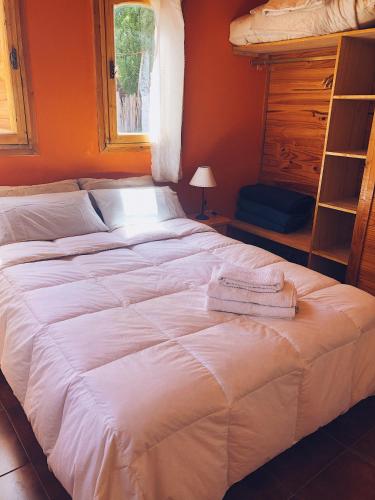 a bed with two towels on it in a bedroom at Terrazas de Uspallata in Uspallata