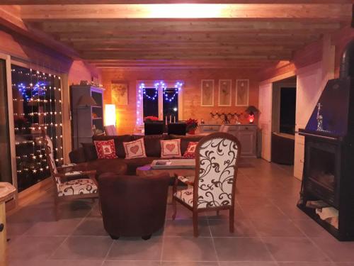 a living room with a couch and a table and chairs at Chalet TERRA LOUP in Le Dévoluy