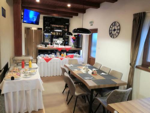a dining room with tables and chairs and a bar at Apartments Club Telgárt in Telgárt