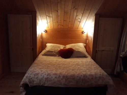 a bedroom with a bed with a red heart on it at Chalet TERRA LOUP in Le Dévoluy