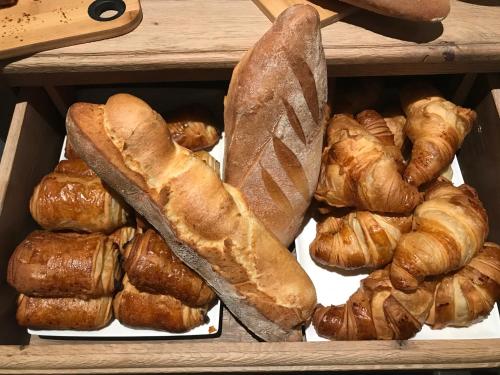 a box filled with different types of bread and croissants at LA GLORIETTE in Marche-en-Famenne