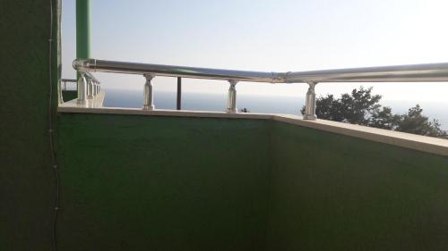 a balcony with a green wall and a window at Villa Vasojevka in Bar, Susanj