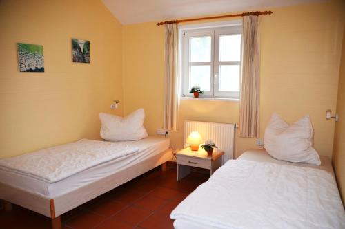 Postel nebo postele na pokoji v ubytování Haus Meerforelle