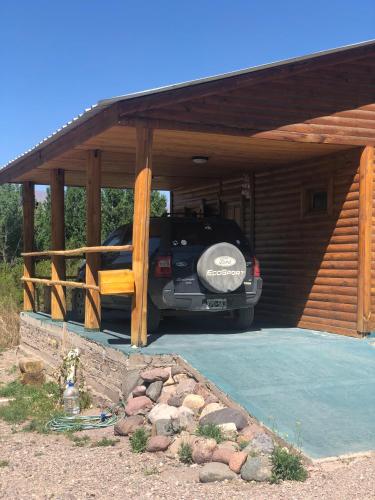 a car parked in a garage with a truck in it at Terrazas de Uspallata in Uspallata