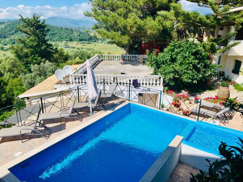 a swimming pool in a villa with a view at Ermones Diamond Villa in Vátos
