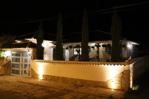 a white house with a white gate at night at Casa Hotel Santa Helena Boutique in Villa de Leyva