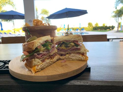 a sandwich on a cutting board on a table at Punta Borinquen Resort in Aguadilla