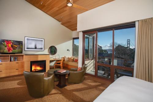 a bedroom with a living room with a fireplace at Cavallo Point in Sausalito