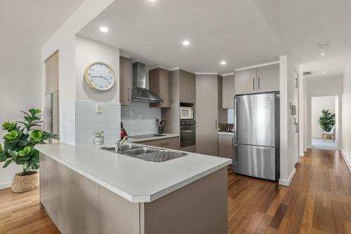 a kitchen with a sink and a refrigerator at Sea Star - Aldinga Beach - C21 SouthCoast Holidays in Aldinga Beach