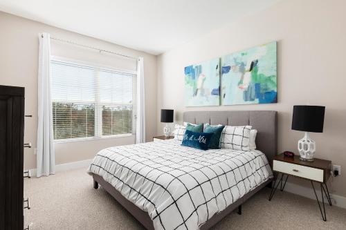 a white bedroom with a bed and a window at Fantastic Townhome 5min Disneyworld 134 in Orlando