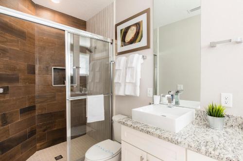 a white bathroom with a sink and a shower at Fantastic Townhome 5min Disneyworld 134 in Orlando