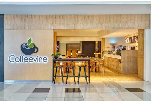 a coffee shop with a table and chairs in a kitchen at Hatten Hotel Melaka in Melaka