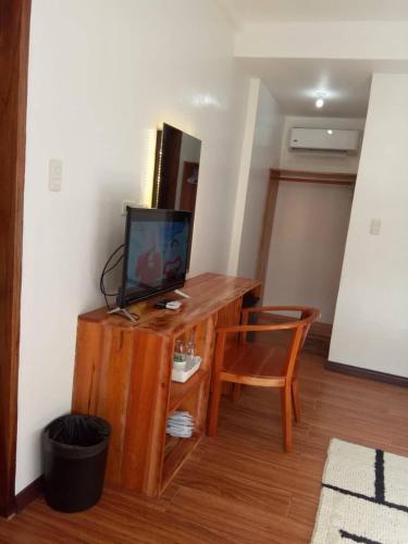a room with a wooden desk with a tv on it at Ananda Resort in Panglao