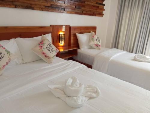 a hotel room with two beds with towels on them at Ananda Resort in Panglao