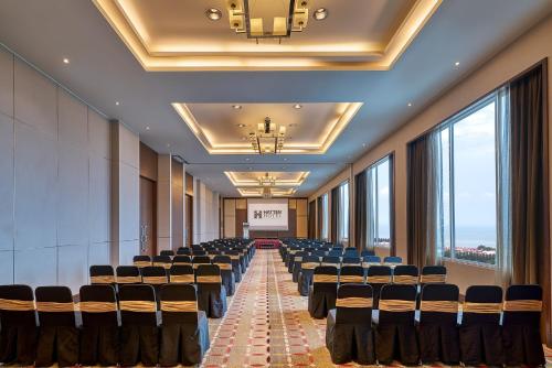 a conference room with chairs and a screen in it at Hatten Hotel Melaka in Melaka
