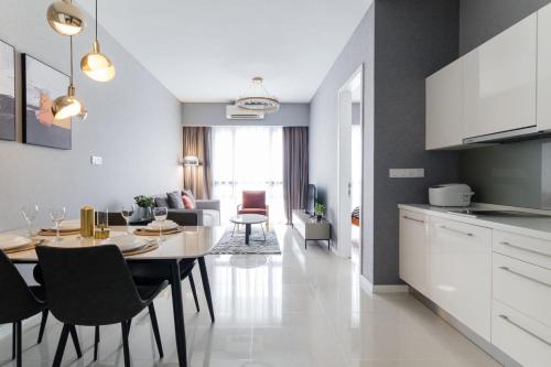 a kitchen and living room with a table and a dining room at Madam Design 2 at Kota Damansara in Petaling Jaya