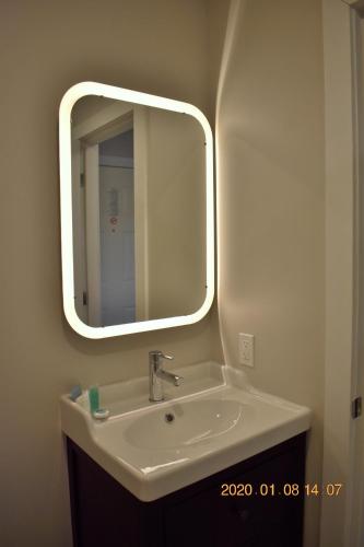 a bathroom with a sink and a mirror at High Point Resort in Quathiaski Cove