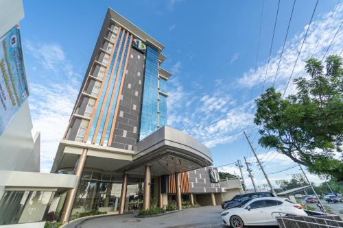 a building with a car parked in front of it at Zuri Hotel in Iloilo City