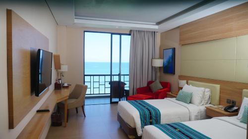 Sotis Hotel Kupang tesisinde bir odada yatak veya yataklar