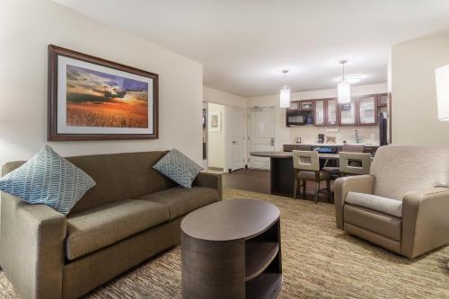 a living room with a couch and a table at Candlewood Suites - Davenport by IHG in Davenport