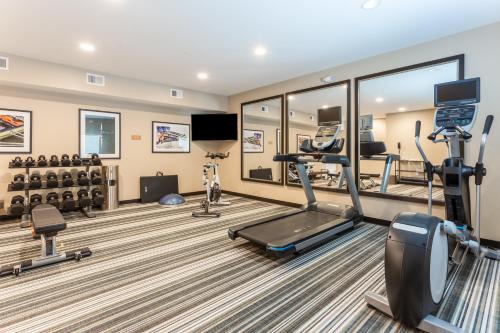 a gym with treadmills and machines in a room at Candlewood Suites - Davenport by IHG in Davenport