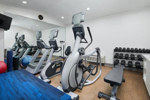 a gym with treadmills and exercise bikes in it at Holiday Inn Express Hotel & Suites Pensacola-West Navy Base by IHG in Pensacola