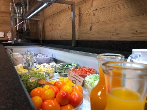 a kitchen counter with a bunch of fruits and vegetables at Hotel Crystal Interlaken in Interlaken