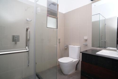 a bathroom with a toilet and a shower and a sink at Nature Trails Boutique Hotel in Unawatuna