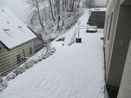 a snow covered street next to a building at Domaine Du Sauveur in Luz-Saint-Sauveur