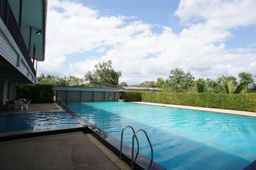 a swimming pool next to a building at แกรนด์ ฟอเรสท์ Grand Forest in Chanthaburi