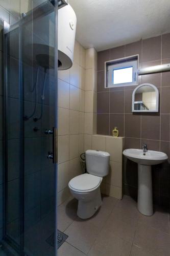 a bathroom with a toilet and a sink at Bitrak Guest House in Ohrid