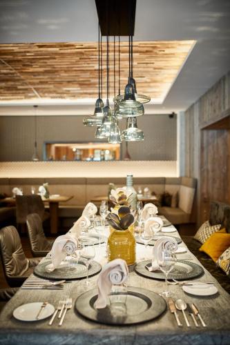 a table with plates and napkins on top at Hotel Alpin Spa Tuxerhof in Tux