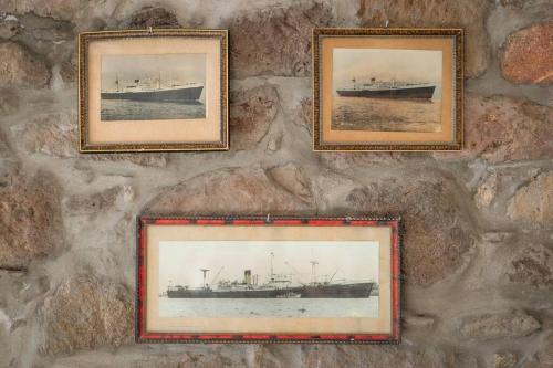 four pictures of a ship on a stone wall at Capetan Nikolas-boat house in Klima