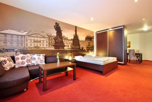 a living room filled with furniture and a large window at Hotel Palác in Olomouc