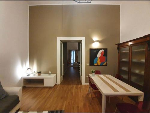 a living room with a table and a couch at Mazzini Privè in Caserta