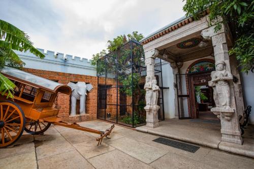 a horse drawn carriage in front of a building at My Village - Eco Rural Resort in Coimbatore