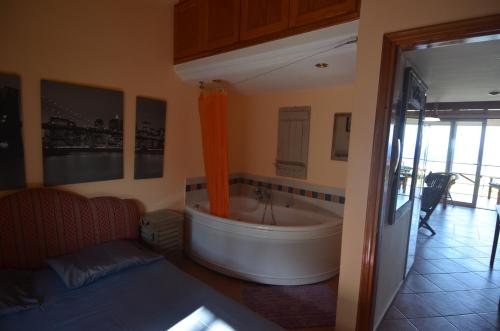 a bathroom with a large tub in a room at Villa Sofia in Marmari