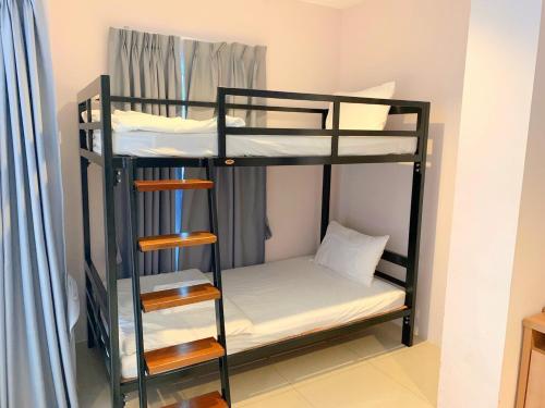 a room with bunk beds in a hostel at The Bedroom Ladprao 101 Bangkok - SHA in Bangkok