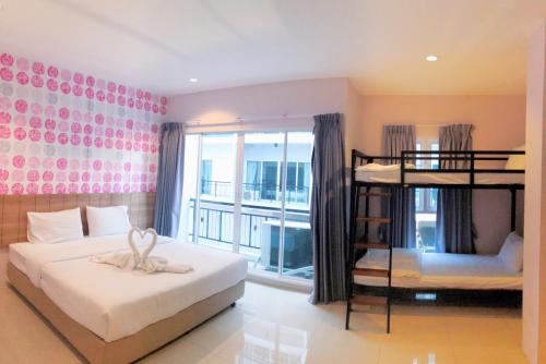 a bedroom with two bunk beds and a balcony at The Bedroom Ladprao 101 Bangkok - SHA in Bangkok