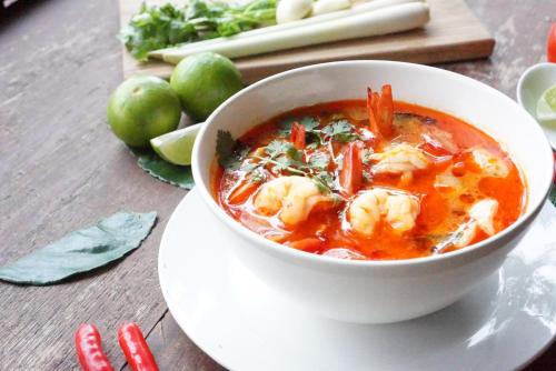 a bowl of shrimp soup on a plate on a table at Tara Lake in Bangkok
