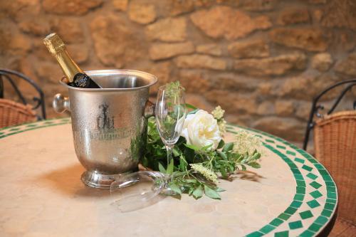 a bottle of wine in a bucket on a table at Hotel Weingewolbe in Bermersheim